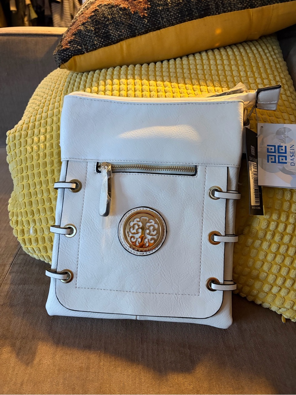 White Crossbody Bag with Decorative Medallion and Gold Accents